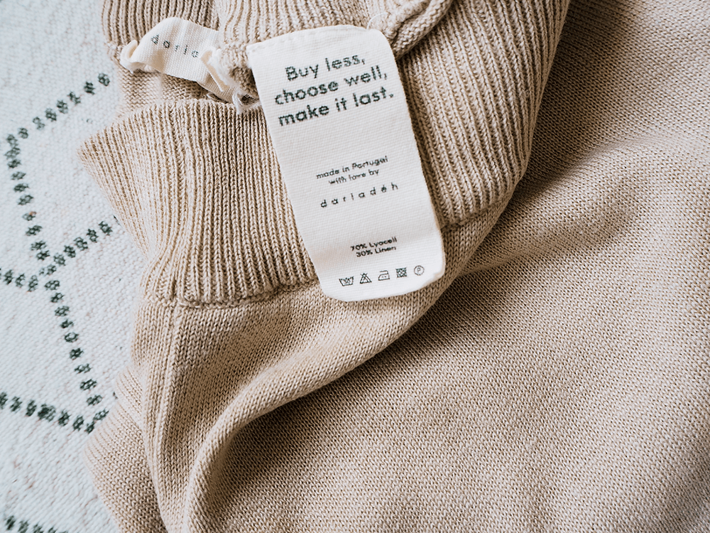 Label of fair fashion garment that sais buy less, choose well, make it last