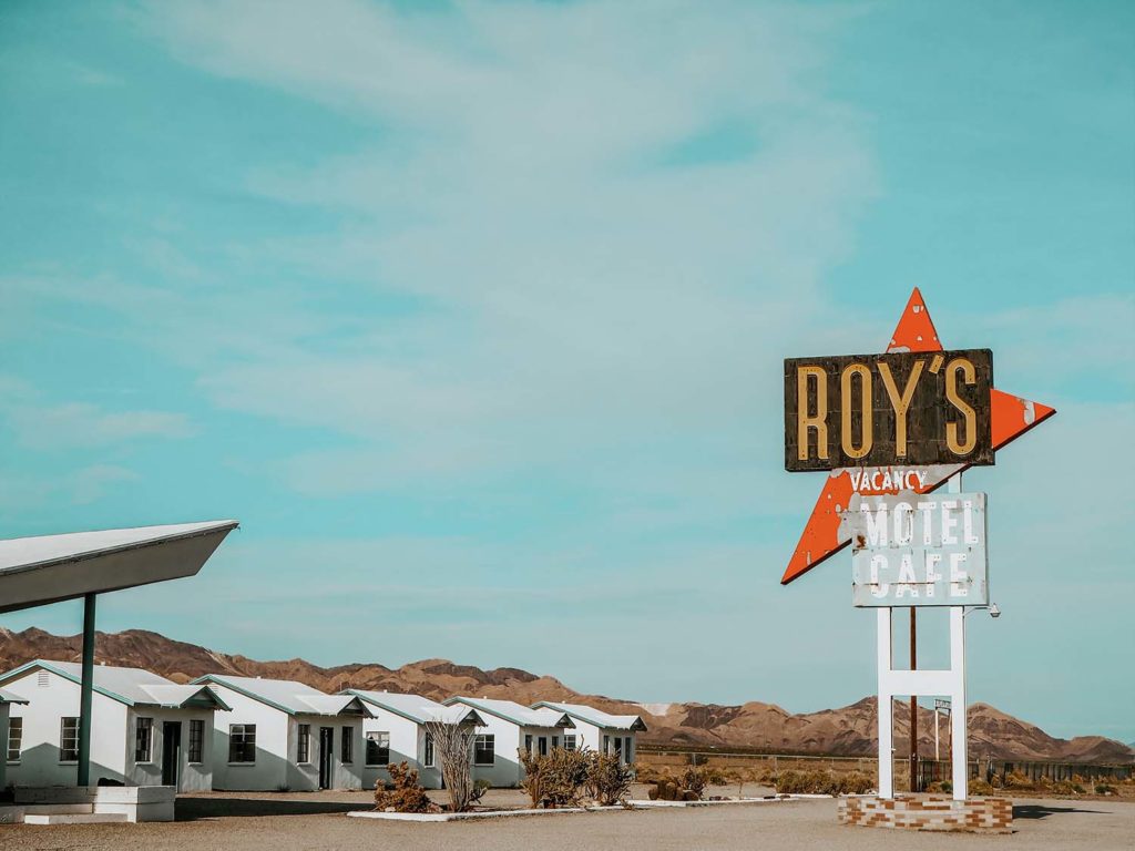 Roy's Motel and Cafe in Amboy Photo picturing the famous road sign and tiny houses as part of the motel